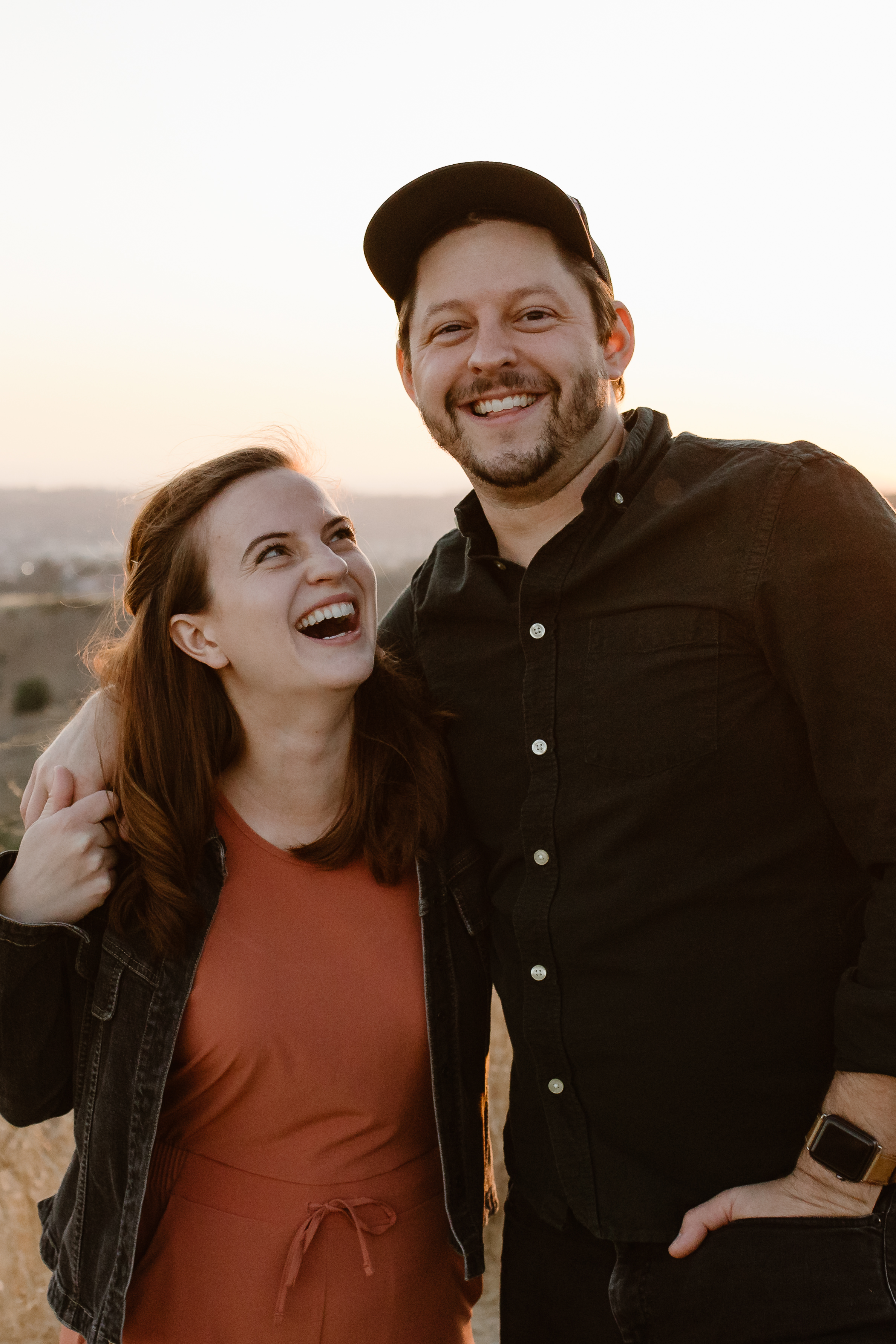 Couple laughs at sunset