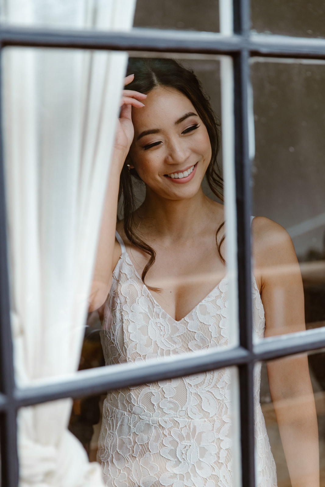 Bride in a window on her wedding day