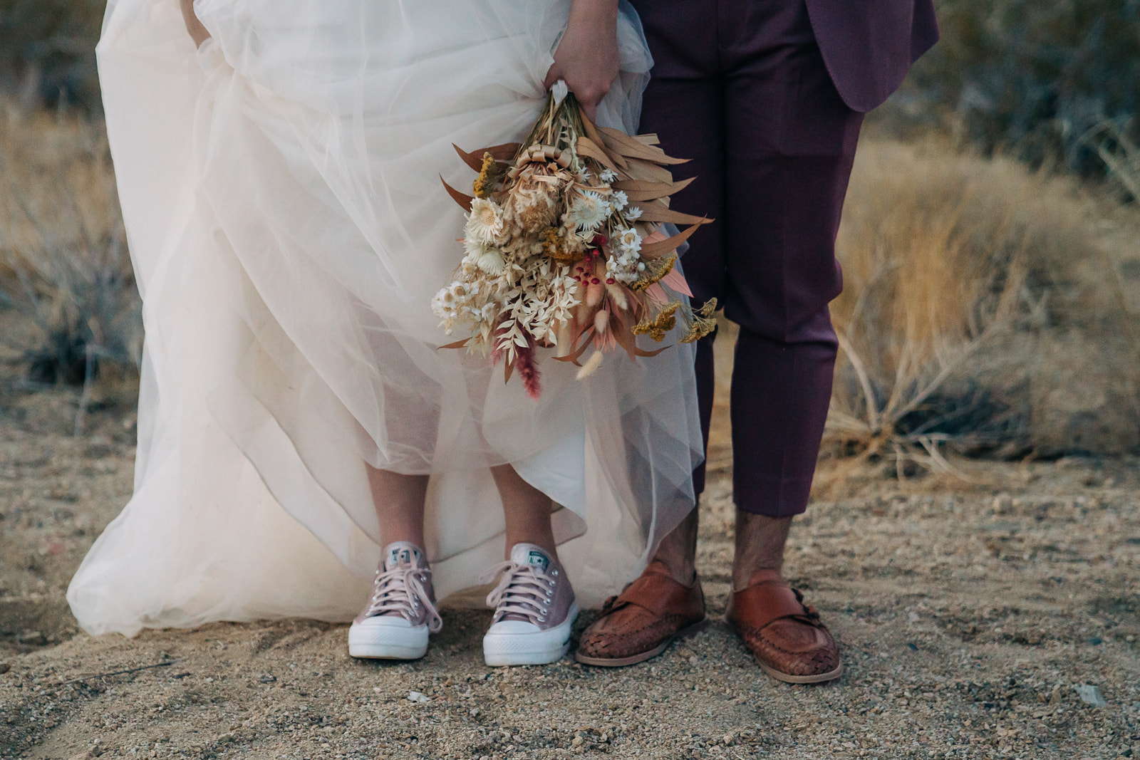 Bride and groom's shoes in the desert