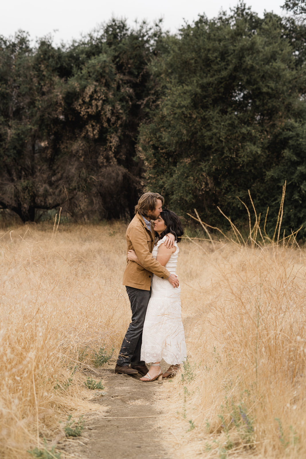 Two people hugging in golden grass