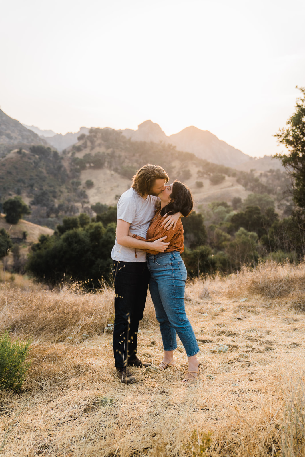 Man and woman kissing at sunset