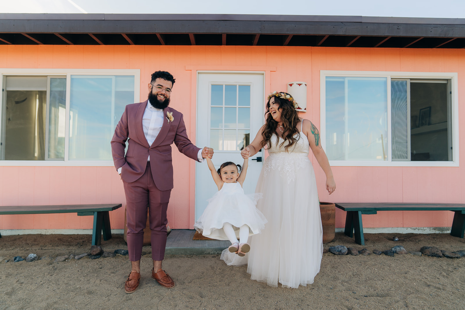 Man, woman and baby celebrate on airbnb wedding day